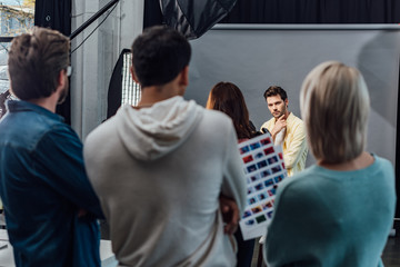 selective focus of handsome model posing in photo studio