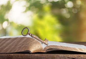 Open book on old wooden table.