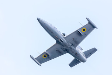 Training fighter plane airborne with view from the ground. Modern real world pilot trainer jet.