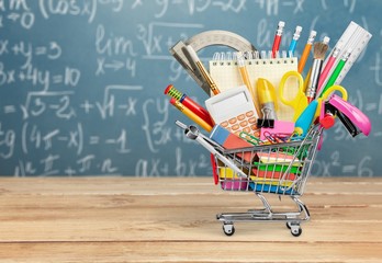 Back to school concept, school supplies in the shopping cart.