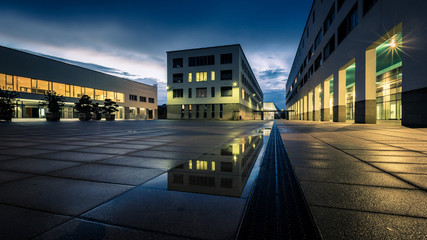 Public buildings at night, urban lighting and rain