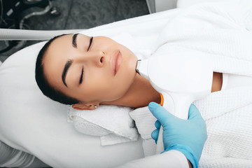 Obraz na płótnie Canvas Laser hair removal on a woman's face. Hair removal on chin