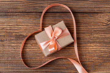 Heart shaped ribbon on a wooden background. Valentine's Day Gift card
