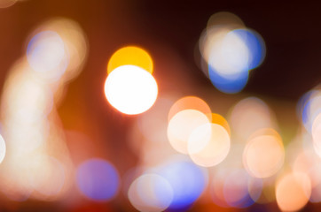 Orange, white, red and blue defocused street lights. Blurred bokeh for festive design