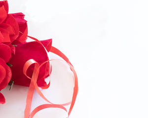 Romantic red color and ribbon symbolize a greeting of love .
