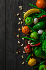 Raw healthy food, grocery set on a black wooden table