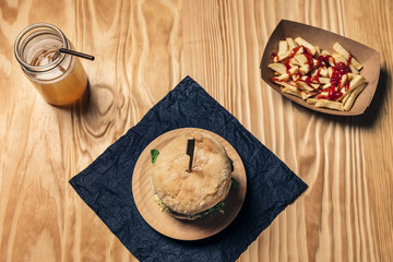 top view of a gourmet hamburger on a wooden table