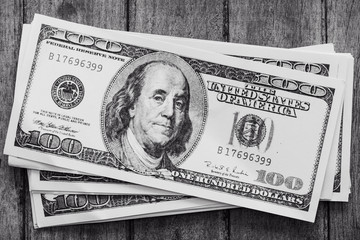 Several dollar bills in black and white