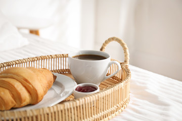 Fototapeta na wymiar Tray with tasty breakfast on bed. Cozy morning