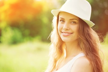 Young woman on field under sunset light