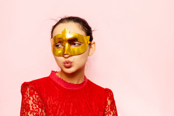 Portrait of beautiful woman in evening dress and golden masquerade mask. Valentines day, Carnival,...