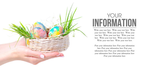 Painted eggs in basket in hand on white background. Isolation. Happy Easter
