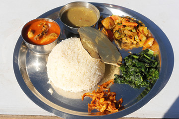 Dal Bhat, Traditional Nepali Food with Curry, Lentils, Rice, Spinach, and pickles