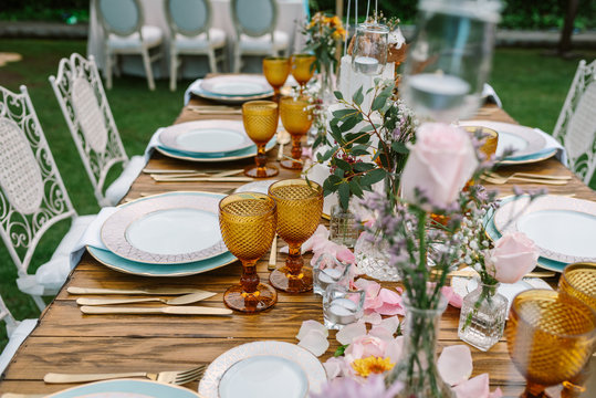 Wedding table decoration in rustic style placed outdoors