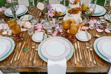 Wedding table decoration in rustic style placed outdoors