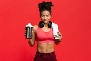 Happy fitness afro girl recommending high quality protein