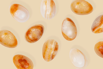 Yellow stone Easter egg pattern. Minimal style composition with Easter design concept. Monochrome colors background. Top view.