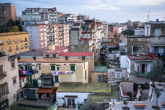 Napoli, Italy - November 23, 2019: From above of old colorful buildings with blue sky on background 