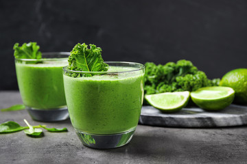 Tasty kale smoothie on grey table, closeup
