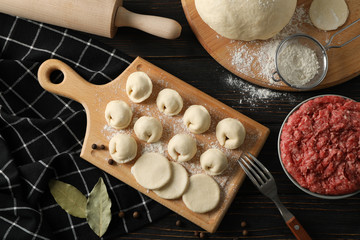 Composition with minced meat and dumplings on wooden background, top view