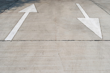 Arrow on the road and white color