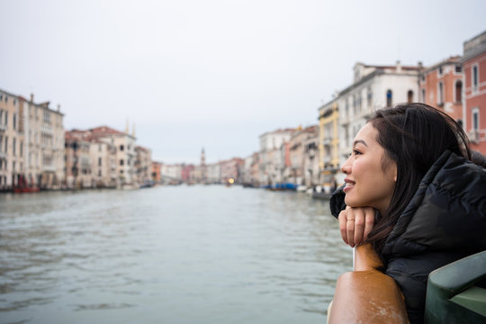Asian female on vacation ob ferryboat on waterline at city