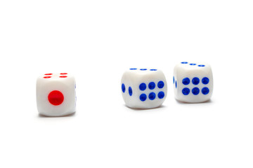 Three dice, one red and two blue on a white background. isolate