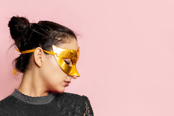 Portrait of beautiful woman in evening dress and golden masquerade mask. Valentines day, Carnival,...