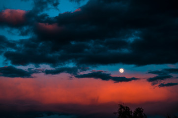 The moon while the sun sets