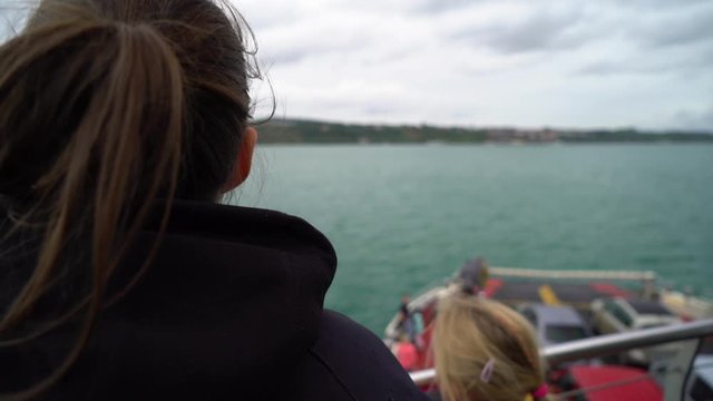 Young woman looking out at ocean from boat