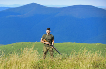 soldier in the field. polygon. army forces. sniper reach target mountain. military style. male in...