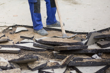 Manual removal of asphalt pavement with a pickaxe