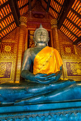 Statue of Buddha in small temple near Wat Chedi Luang temple, Thailand. Spiritual place with beautiful ornaments and textures. Famous tourist destination