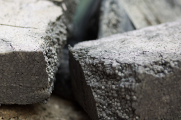Old black broken styrofoam package block in waste container