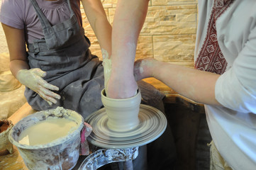 Pottery lesson, only hands are visible