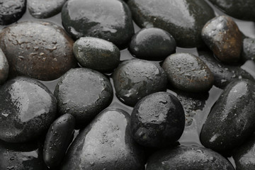 Spa stones in water as background, closeup. Zen lifestyle