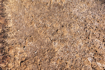 red surface of the stone mountain texture and background with brown tint and gravel stones