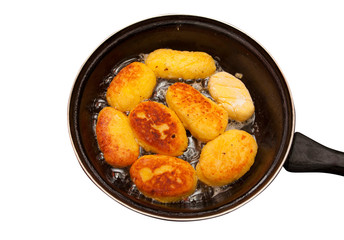 roasted and boiled donuts in the pan isolated on white