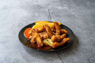 Fish and Chips made with Breaded and Fried Seabass in Black Plate.
