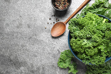 Fresh kale leaves and pepper on grey table, flat lay. Space for text