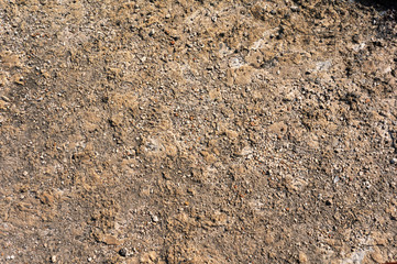 surface of the stone mountain texture and background with brown tint and gravel stones