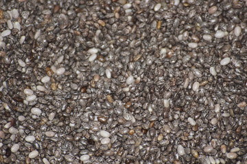 pile of dry chia seeds spice macro as background