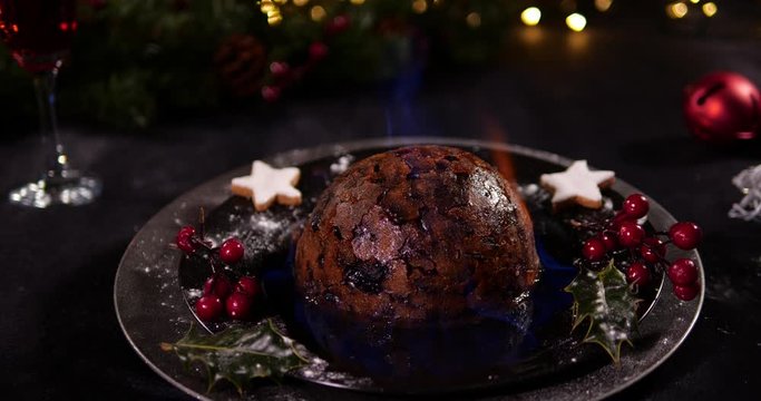 Christmas Pudding with flames / Plum / Figgy - British Traditional Christmas dinner festive desert. Tracking Shot shot