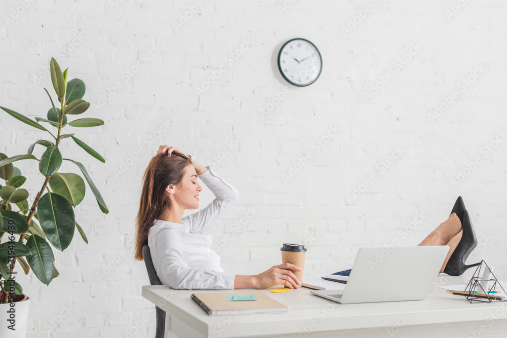 Wall mural side view of happy businesswoman chilling in office