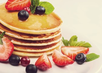 Pancakes with butter and syrup and colorful fruit