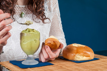 Feel of freshness: girl eating a typical sicilian pistachio granita with a warm brioche - 315417019