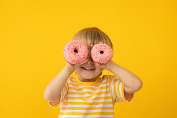 Happy child holding glazed donut
