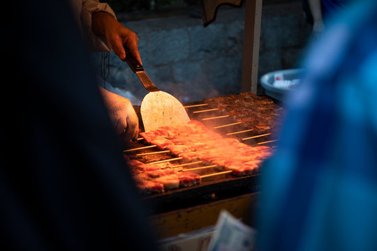 Japan, Kyoto Prefecture, Kyoto City, Hands of chef preparing?yakitori?at food stand