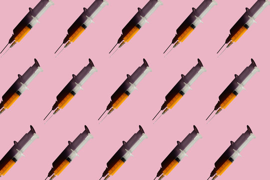 3D Illustration of syringes, pink background
