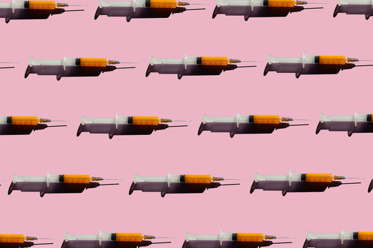 3D Illustration of syringes, pink background